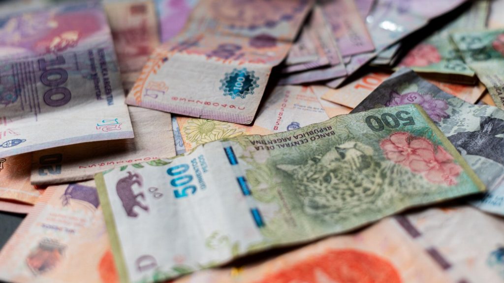 A detailed image showcasing various Argentine peso banknotes in vivid colors.